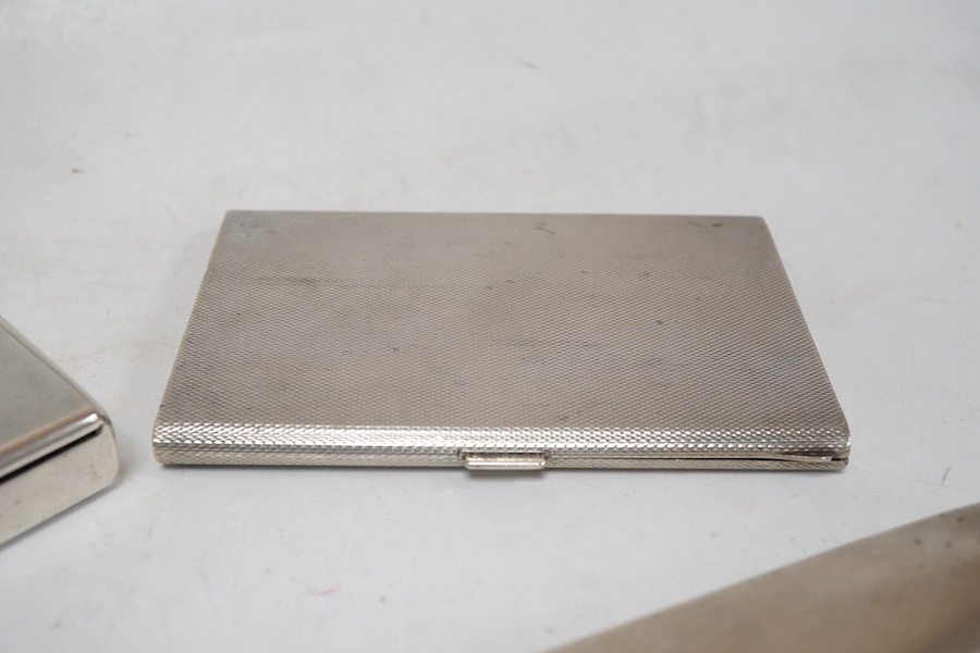 An engine turned 800 standard white metal cigarette case, 12cm, a 1920's Russian 875 standard white metal cigarette case and a white metal paper knife or page turner.